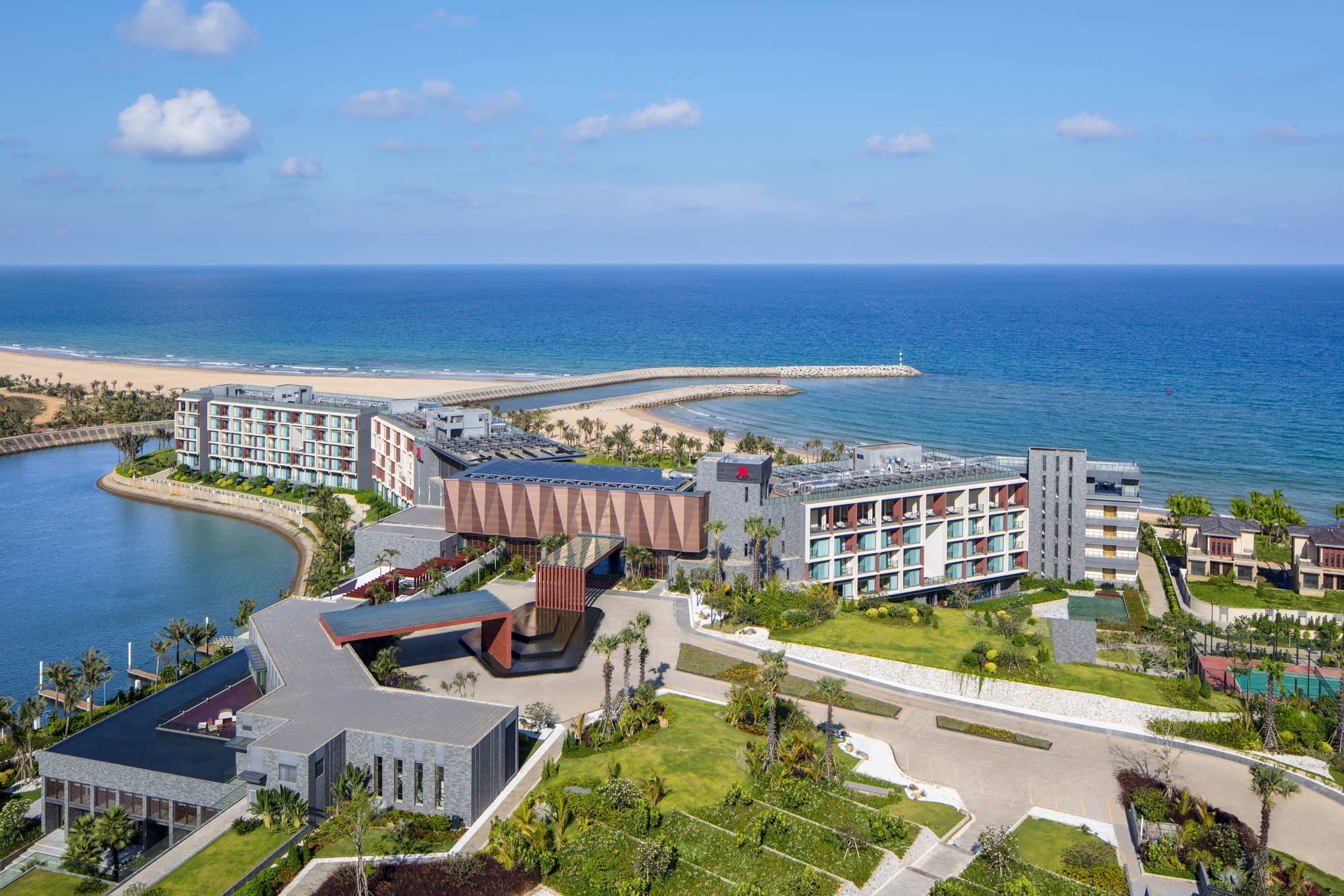 Oceanfront view of Xiangshui Bay Marriott Resort & Spa in Sanya featuring tropical pools.