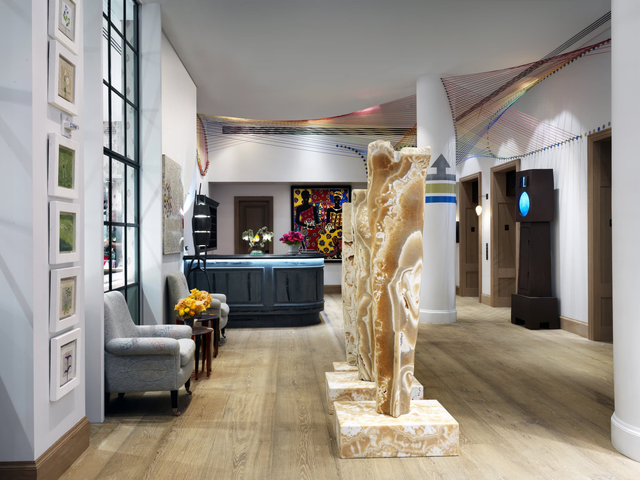 The Whitby Suite's private terrace with colorful patterned furniture, overlooking the Midtown Manhattan skyline.