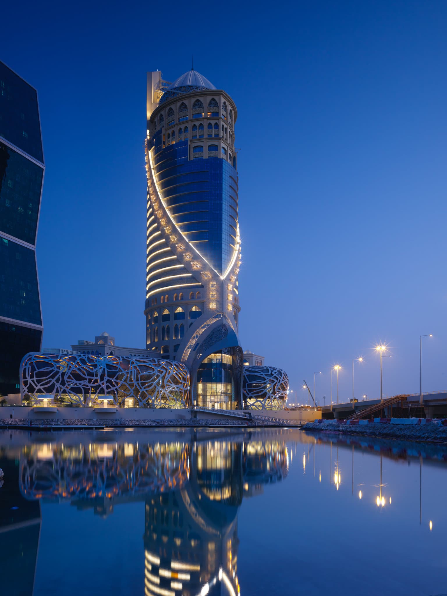 The Mondrian Doha's 'Black Helix' staircase, a spiraling architectural masterpiece with ornate balustrades.