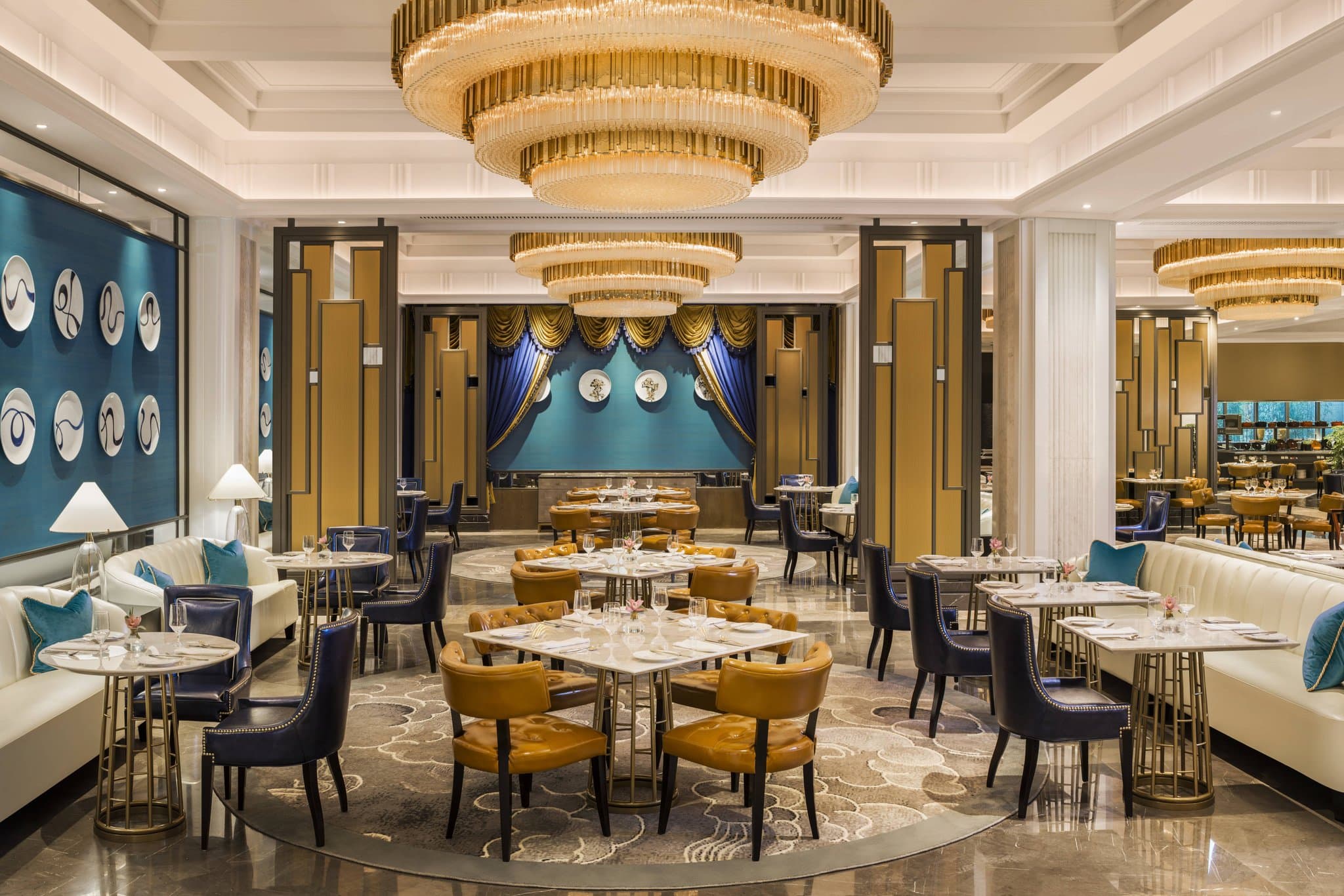 Lobby of The St. Regis Shanghai Jingan featuring Dale Chihuly glass sculptures and a grand Art Deco spiral staircase.