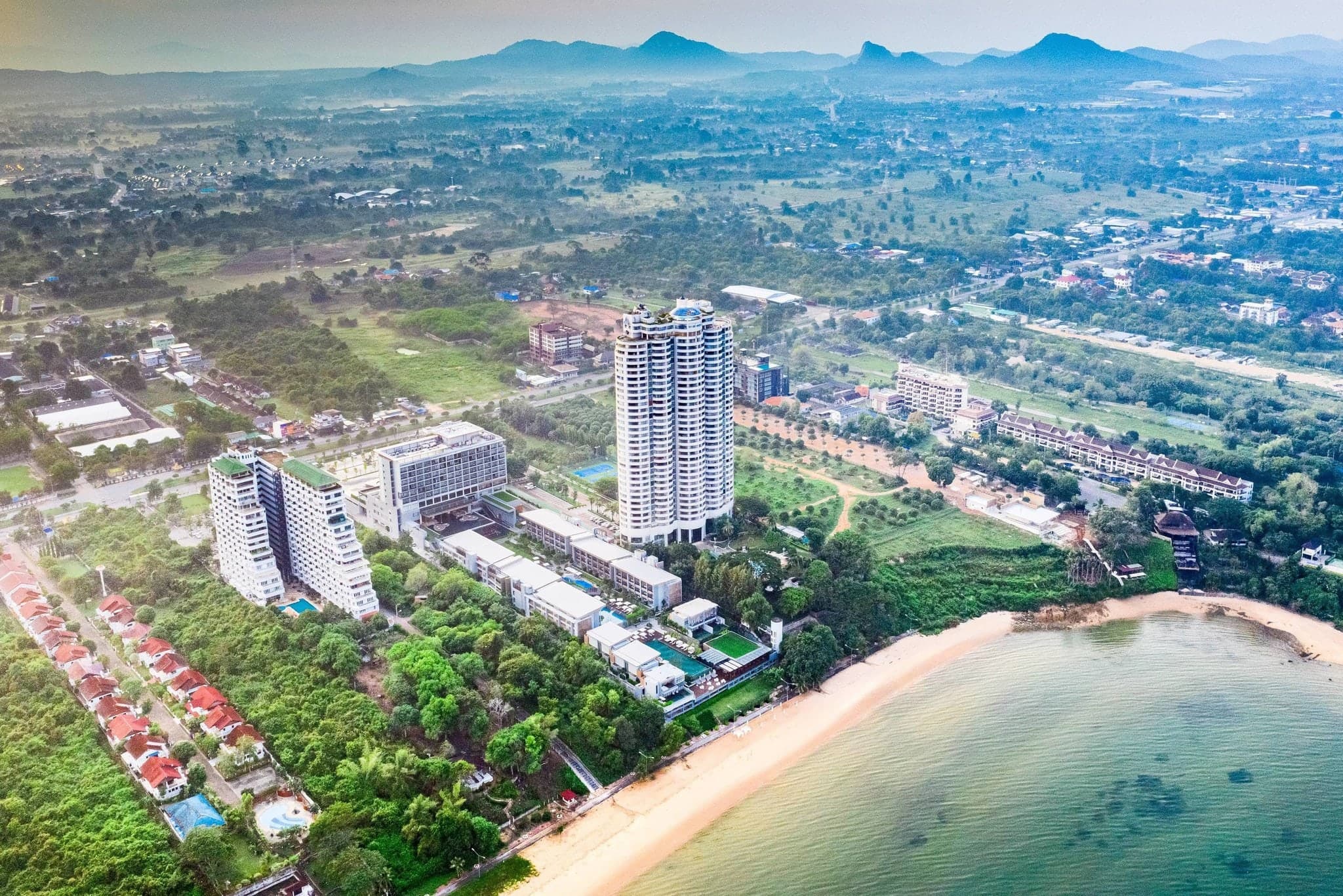 The geometric Grand Staircase at Renaissance Pattaya leading down to the infinity pool and the Gulf of Thailand at sunset.