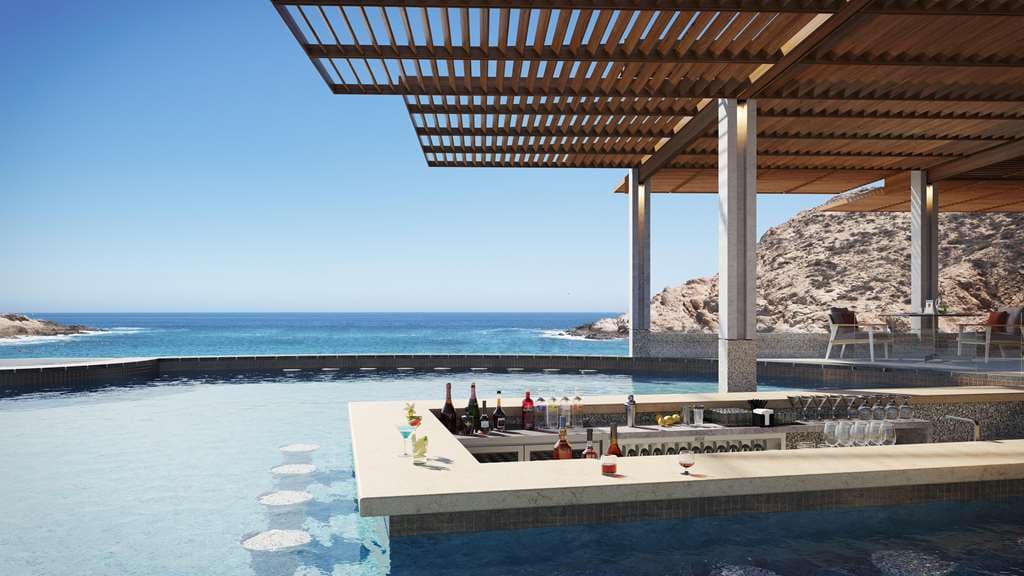 Montage Los Cabos infinity pool merging with the turquoise waters of Santa Maria Bay, framed by desert landscaping.