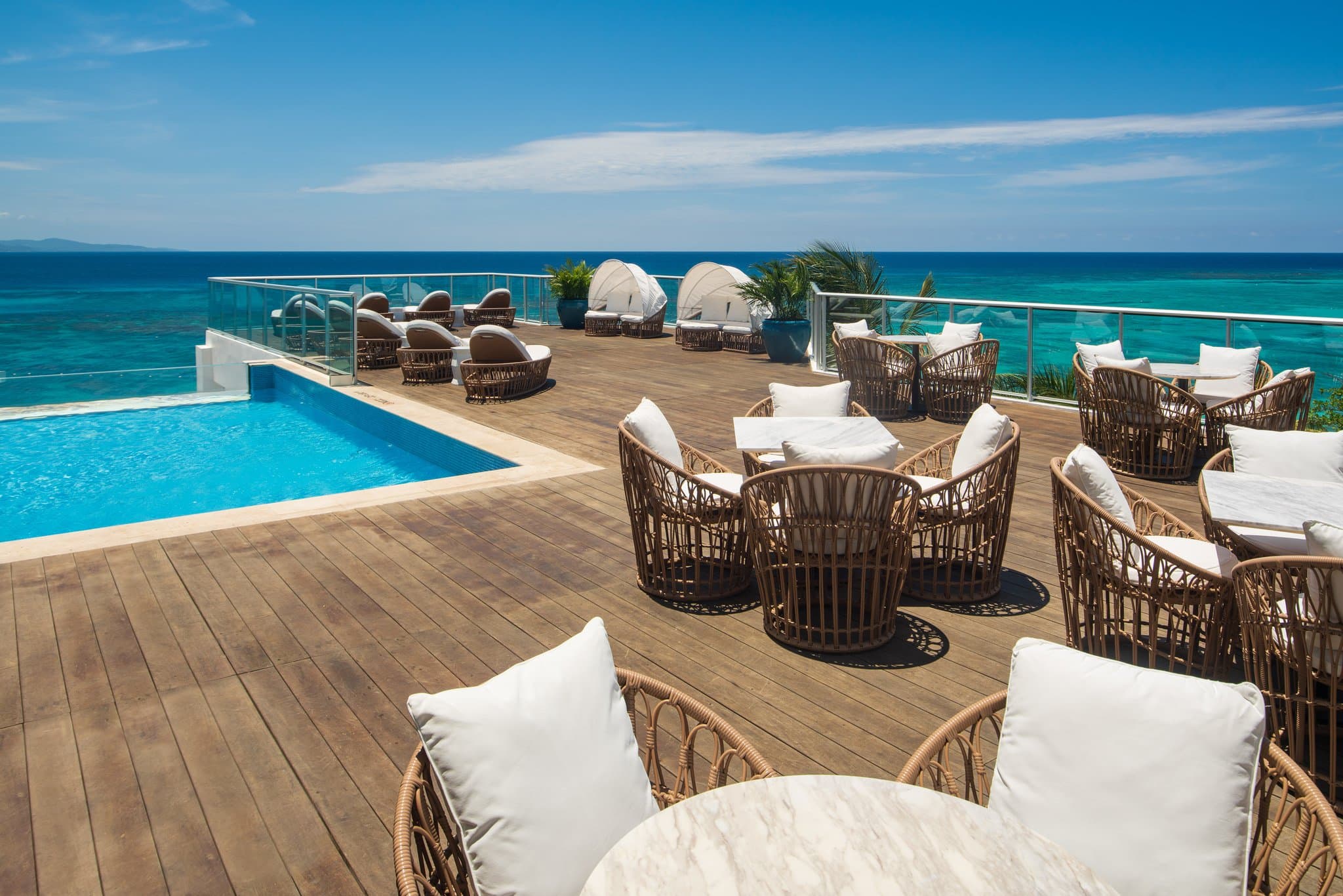 The glass-enclosed Sky Deck infinity pool at S Hotel Montego Bay at sunset, overlooking the Caribbean Sea.