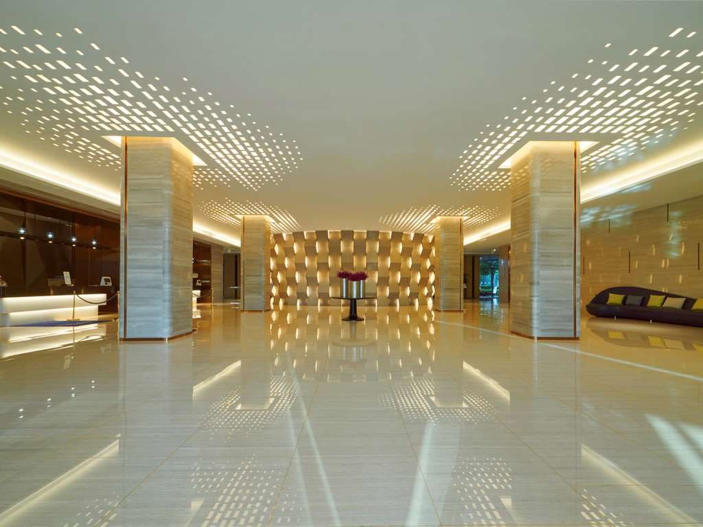 A whimsical B.Duck themed family suite at Novotel Guiyang Panjiang featuring yellow bedding and cartoon wall art.
