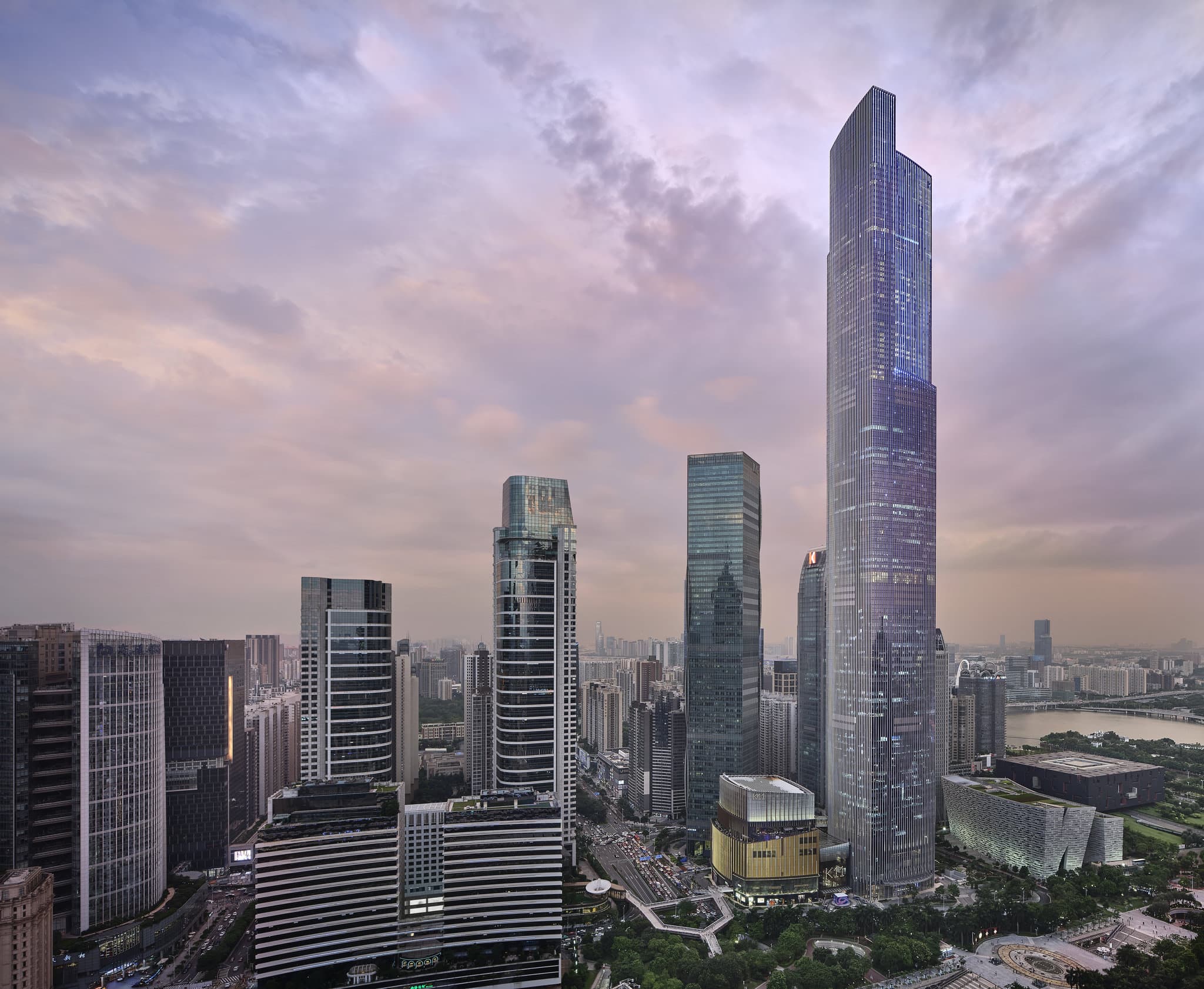 Luxurious guest room at Rosewood Guangzhou featuring panoramic views of the city skyline and Pearl River.
