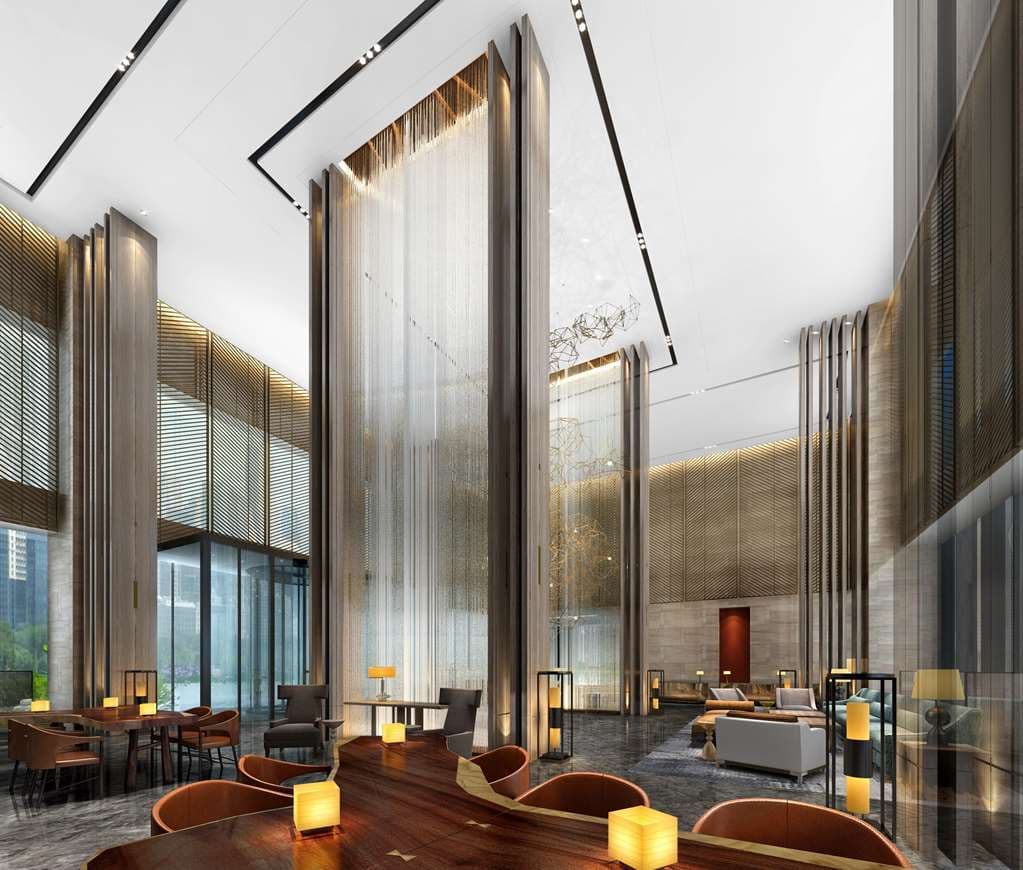 Golden kinetic sculpture in the lobby of Hilton Guiyang with interior waterfalls and marble flooring.
