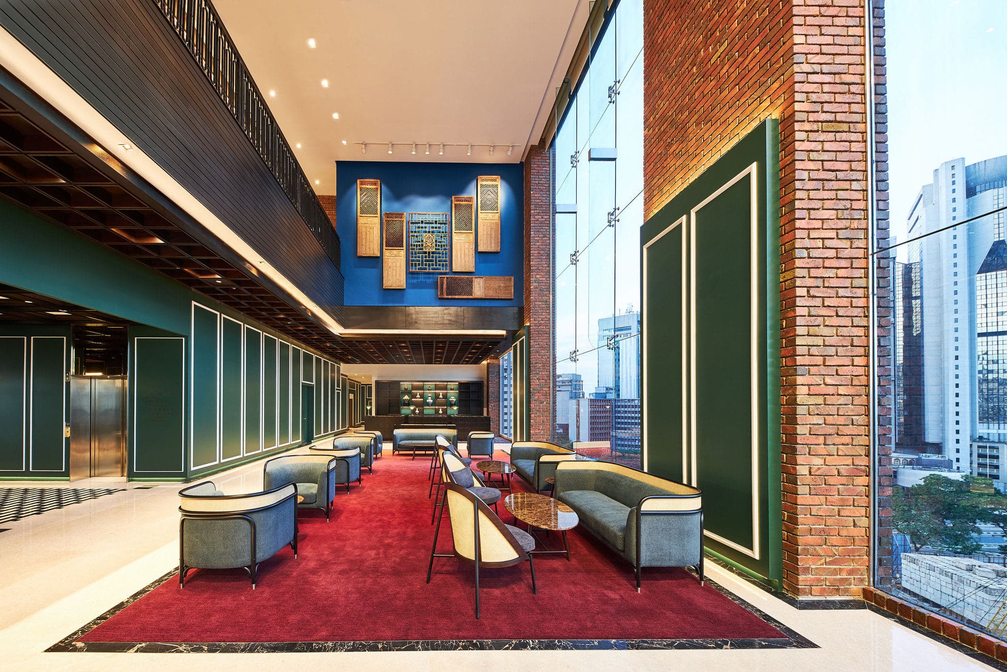 A dramatic view of the jade-tiled Jann bar counter at Four Points Chinatown, with the illuminated Kuala Lumpur skyline and Merdeka 118 visible through floor-to-ceiling windows.