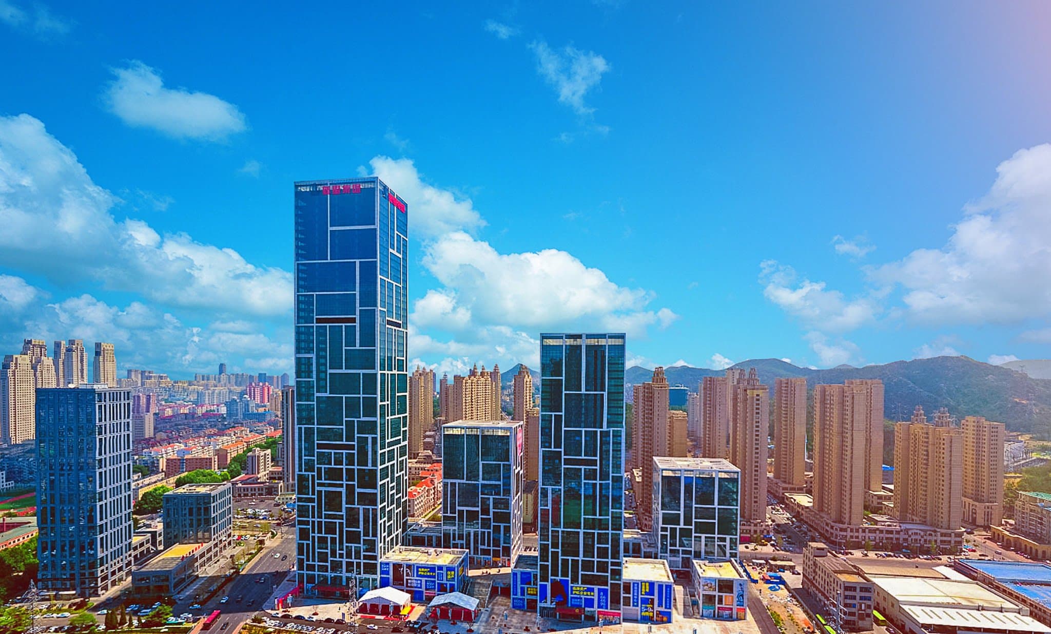 View from a high-floor window at Crowne Plaza Dalian Xinghai looking out over the Xinghai Bay Cross-Sea Bridge and the distant castle hotel.
