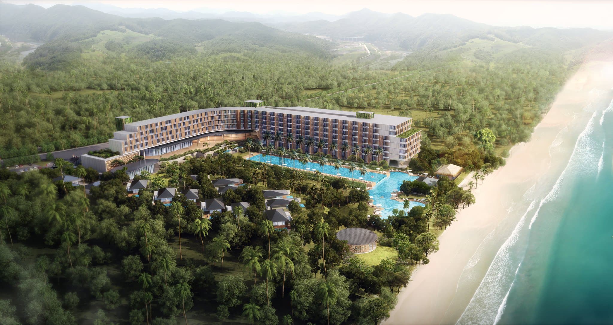 Sunset view from Amber Sands Beach Club at Crowne Plaza Phu Quoc showing the lagoon pool and fire show setup.