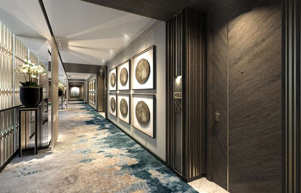 The grand Waldorf Astoria Kuwait lobby featuring the signature 'Icarus' clock and spiral staircase.